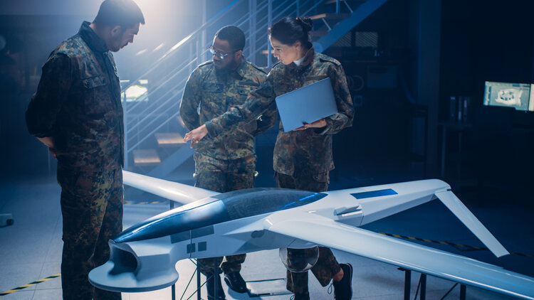 Soliders reviewing a drone